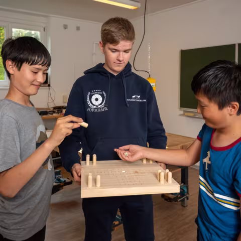 Leben im Internat und soziales Miteinander: Schüler in Werkstatt bei einem Spiel